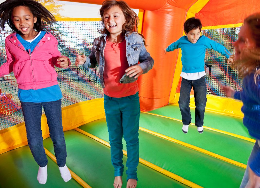 kids jumping in a bouncehouse